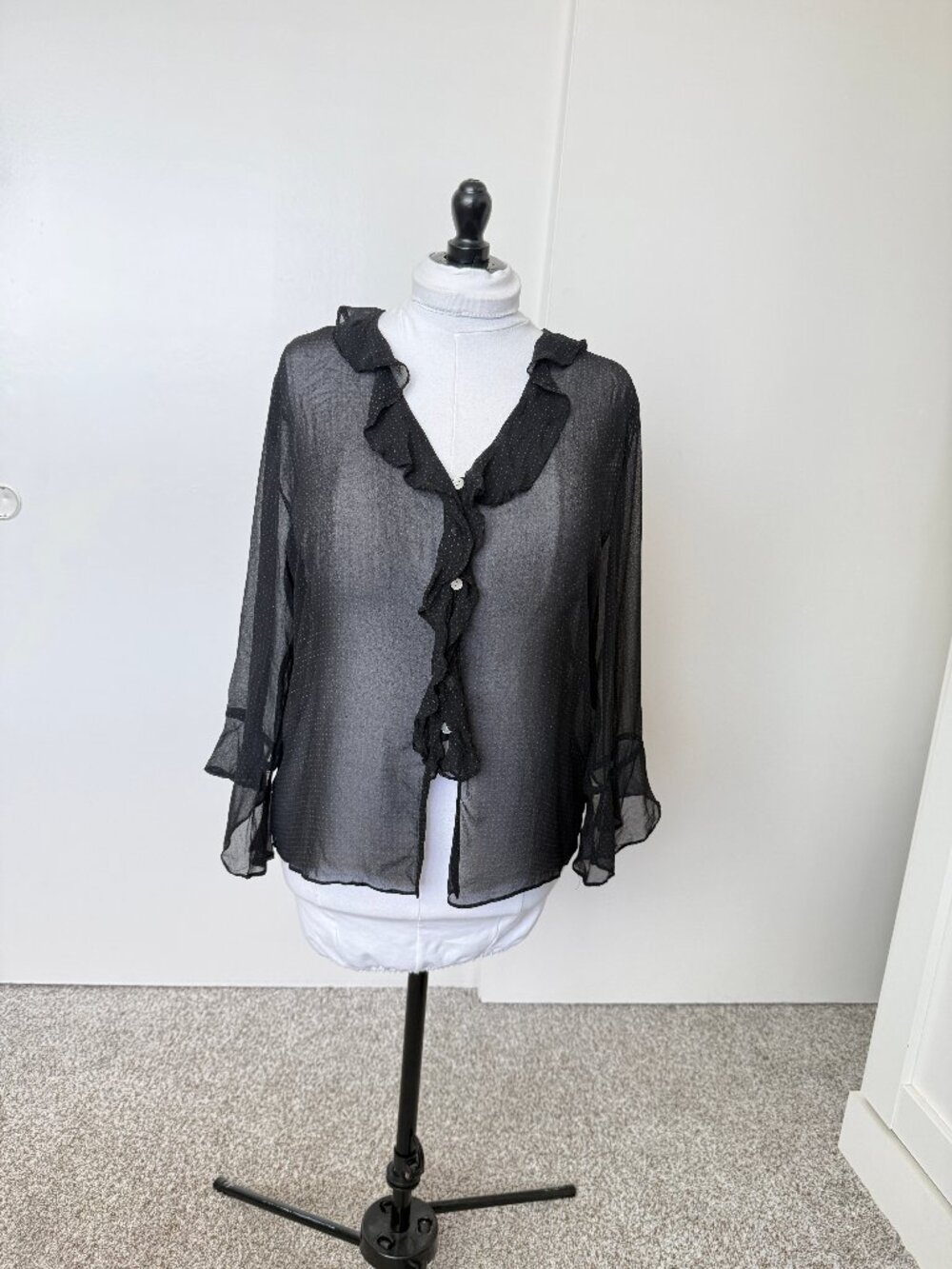 Black sheer blouse with pink polkadots.